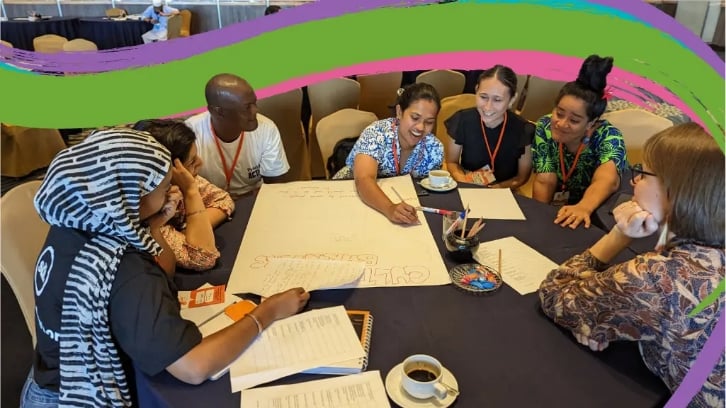 People sit around a table in conversation during CBA17 conference