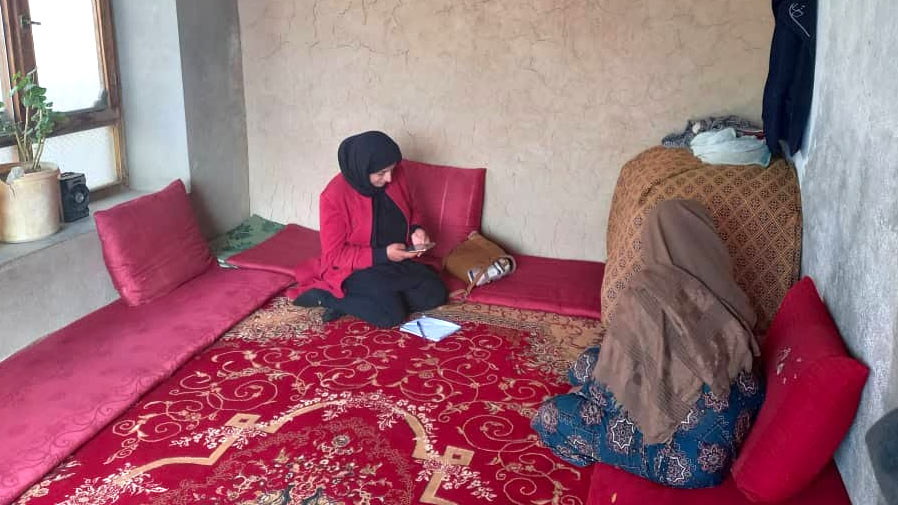 Two women sit speaking to each other