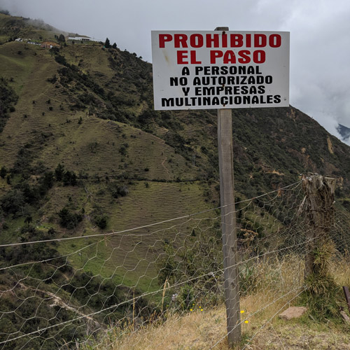 A sign on a hillside reads 'No entry for unauthorised personnel and multinationals'