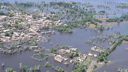 An aerial view of a town covered in floodwater.
