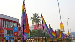 A series of rainbow flags outside a building. 