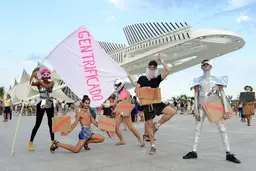 Five people posing with signs that read "gentrificado"