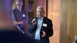 Salemuul Huq holding a microphone to his mouth