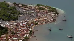 Aerial view of flooded coastal town and destroyed housing