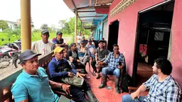 Group of people sitting on chairs facing each other