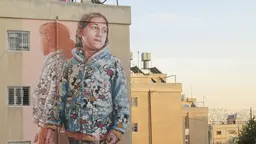 Building with a mural of a young girl.