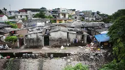 Aerial view of informal housing surrounded by garbage.