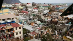 Aerial view of destroyed housing and infrastructure.