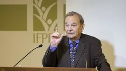 Gordon Conway speaking in front of a microphone.