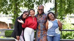 Four women smiling at the camera.
