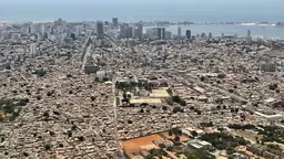 Aerial view of an city with the sea in the background.