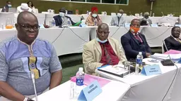 Men sitting at a conference table.