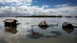 Houses submerged by rising water in one of Bangladesh's coastal areas.