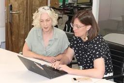 IIED staff members looking at a laptop, discussing