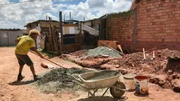 Man moving cement in Ocupação Jorge Hereda, São Paulo.