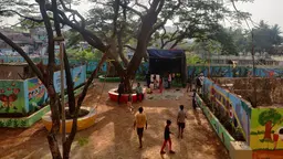 Children walking and playing around a court yard.