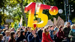 Protester holding up a sign that show 1.5 degrees.