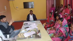 Group of women sitting in the office of a government official, discussing.