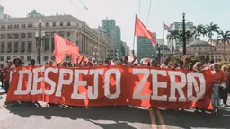 Group of people gathered for a protest in Sao Paulo, hoping a big sign that reads 'Despejo Zero'.