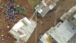 An aerial view of an informal settlement and people from very high.