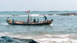 Boat of fisherman returning to shore in Ghana
