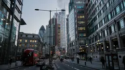 London street during night time, with cars on the roads and people walking on the side walks.