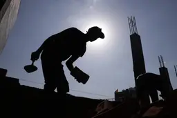 A builder labours in the sun in India. Outdoor workers lose weeks of work every year due to extreme heat