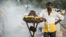 Man selling fruit and vegetable on the busy streets in India.