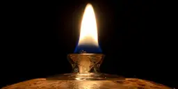 Closeup of the flame of a small oil lamp.
