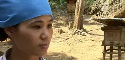 Ha Thi Ngan, a beekeeper, surrounded by her bee hives. 