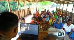 Group meeting on climate change on boat run by Shidhulai. Natore, Bangladesh. Photo: G.M.B. Akash/PANOS 