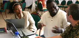 Isilda Nhantumbo, Bright Sibale, and Duncan Macqueen exchange ideas at a Forest Governance Learning Group Learning Event in Mozambique. Photo: Leianne Rolington