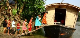 Children go to school on boat in flood-prone Bangladesh. Photo: G.M.B Akash/Panos