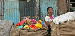 Closing sacks of sorted plastic for recycling at the Banvari Compound at Dharavi.Credit Meena Kadri. Creative Commons. http://creativecommons.org/licenses/by-nc-nd/2.0/deed.en_GB