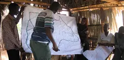 Maps drawn by community groups before being transferred to a geo-referenced satellite map projected on a wall (Photo: James Pattinson)