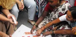 Residents of an informal settlement in Pune, India, discuss the results of a survey and how best to upgrade their homes and settlement, guided by Mahila Milan, a grassroots network formed by savings groups of women slum and pavement dwellers (Photo: SPARC)