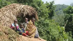 A family guards their crops from wild animals on the boundary of Bwindi Impenetrable National Park (Photo: Mariel Harrison)