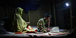 Low-cost solar lanterns enable a boy to study at home in the small village of Shidhulai in the Natore District of northwestern Bangladesh (Photo: G.M.B. Akash/PANOS)
