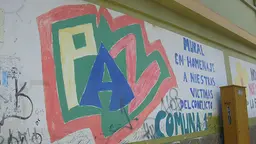 "Paz" (peace) graffiti in Medellín, Colombia. The text to the right translates as "Mural in tribute to our victims of conflict" (Photo: Cathy McIlwaine)