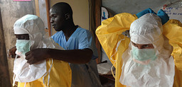 Care workers in Guinea put on protective clothing (Photo: EC/ECHO)
