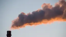 The sun glints on smoke above Beijing. China is on course to see overall coal consumption peak this year (Photo; GadgetDan via Creative Commons)