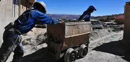 Miners pushing a cart out of a mine near the Bolivian town of Potosi. For centuries this area had the richest silver mines in South America. Today many of the mines are worked by local cooperatives, but conditions are still harsh (Photo Nyall & Maryanne, Creative Commons via Flickr)