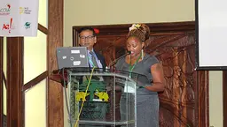 Standing alongside IIED senior fellow Saleemul Huq, Evah Wanjiru reads her poem 'Shadows in the child's memories' to participants at CBA9 (Photo: Matt Wright/IIED)