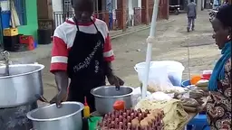 Muganda at his stall at Karango town with Medius Bihunirwa, a researcher with the Kabarole Research and Resource Centre (Photo: Kabarole Research and Resource Centre)