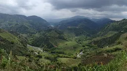 An image of a river splitting the hills of the Chinchiná River Basin in Colombia, one of eight countries in which IIED worked with the World Bank on natural capital accounting (Photo: Rosalind Goodrich/IIED)