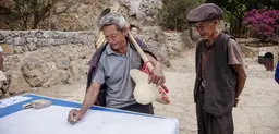 Indigenous mountain farmers examine a map of the Stone Village water management system, showing the water channels (Photo: Irene Song)