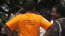 The slogan on a woman T-shirt in Kitwe, Zambia - emblazoned with 'Addressing water and sanitation challenges through city-wide partnerships' - highlights the community-led approach (Photo: Diana Mitlin/IIED)