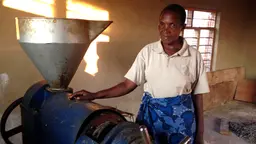  Esther Msafiri demonstrates using electricity for oil pressing in Njombe region, Tanzania (Photo: Sarah Best/IIED)
