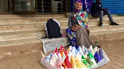 A Congolese vendor sells handkerchiefs on the pavement in central Kampala. Congolese refugees dispersed throughout the city often lack the social and economic support networks necessary to find work or to start a business (Photo: William Monteith/IIED)
