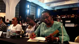 Cecilia Silva and Carla Silva Pompilio from Angola, browsing through ‘Becoming a UNFCCC delegate’, Marrakech, November 2017 (Photo: Janna Tenzing/IIED)